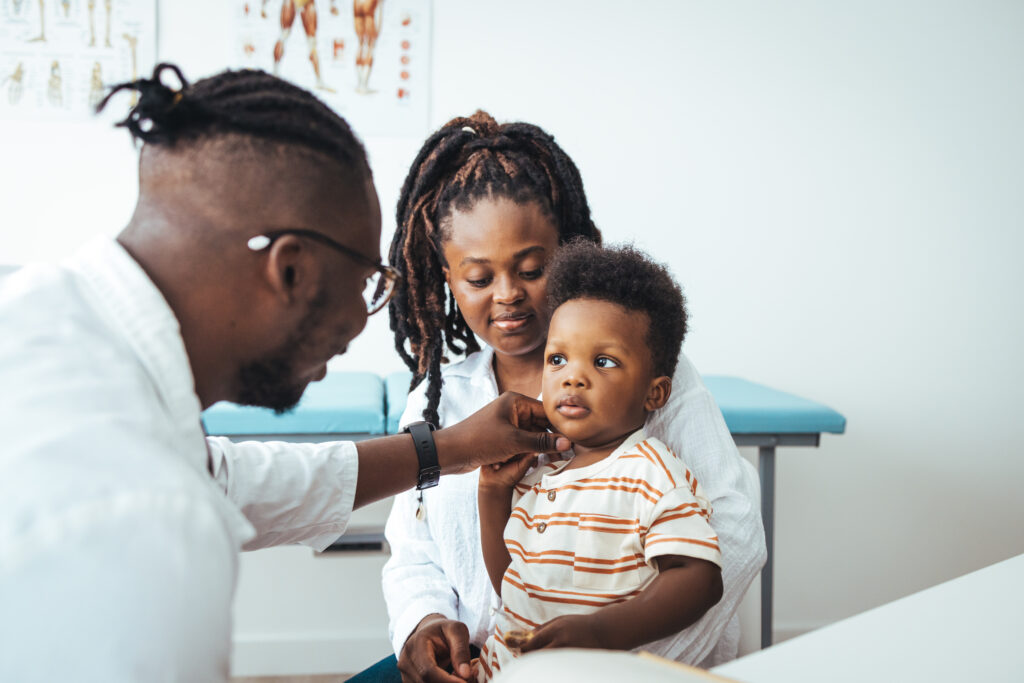 African male pediatrician hold stethoscope exam child boy patient visit doctor with mother, black paediatrician check heart lungs of kid do pediatric checkup in hospital children medical care concept